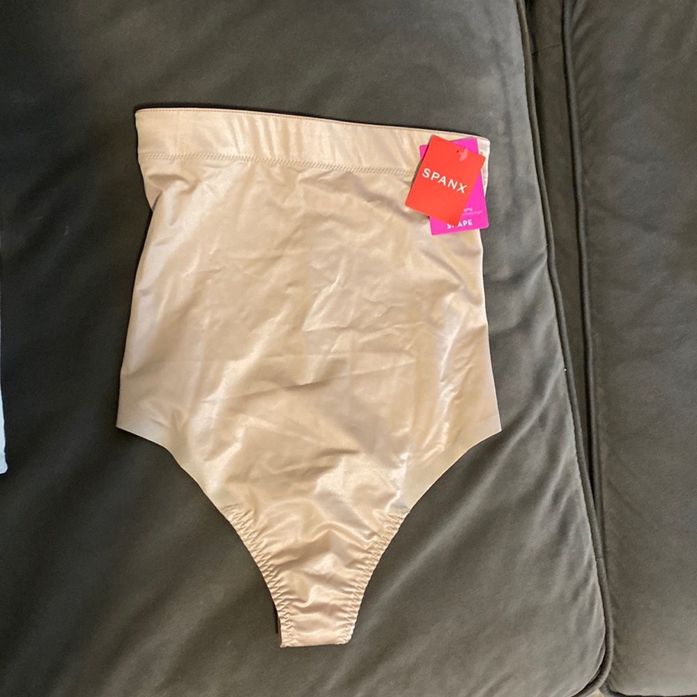 Spanx shapewear thong. Never worn. Tags on. Tan color. Size small.
